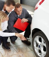 Mechanic with customers in a garage